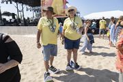 Jeff Glass, left, and Flo Glass wore their snow shoes to walk across the sand at the Burning Foot Beer Festival at Pere Marquette Beach in Muskegon on Saturday, Aug. 26, 2023. (Ridley Hudson | MLive.com)