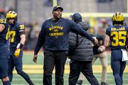 Michigan co-offensive coordinator Sherrone Moore takes the field before Michigan football’s Spring Game at Michigan Stadium in Ann Arbor on Saturday, April 2, 2022.