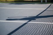A shadow of a tennis player casts on the court during the Bay County Tennis Championship on Friday, Sept. 17, 2021. (Kaytie Boomer | MLive.com)
