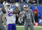 Detroit Lions place kicker Michael Badgley (17) pumps his fist as Buffalo Bills running back Taiwan Jones (25) reacts to the field goal during the second half of an NFL football game, Thursday, Nov. 24, 2022, in Detroit. (AP Photo/Duane Burleson)