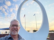 John Hiner, VP of content for MLive Media Group, takes a selfie in front of one of Bay City's most notable icons – the Ring of Friendship sculpture and fountain in Wenonah Park, on the riverfront downtown.