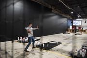 Washtenaw County Contract association employees play a game of fowling during the soft launch at Fowling Warehouse in Ypsilanti on Friday, April 8, 2022. 